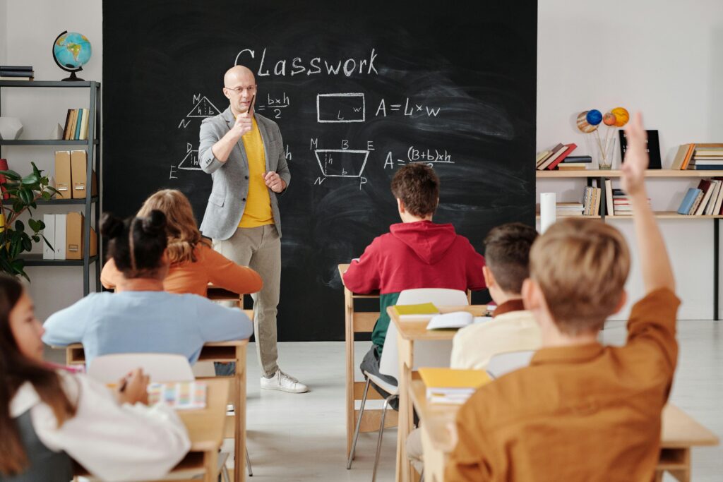 Home Teacher explaining geometry as students engage in a modern classroom setting.